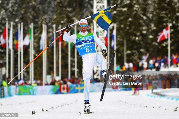 Marcus Hellner of Sweden, skiing in the Free style, crosses the finish line ranked first during the cross country skiing men's 4 x 10 km relay on day...