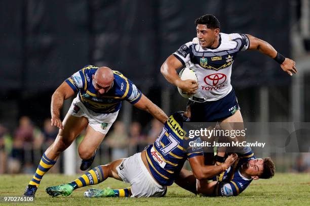 Jason Taumalolo of the Cowboys is tackled during the round 14 NRL match between the Parramatta Eels and the North Queensland Cowboys at TIO Stadium...
