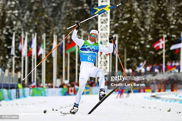 Marcus Hellner of Sweden, skiing in the Free style, crosses the finish line ranked first during the cross country skiing men's 4 x 10 km relay on day...