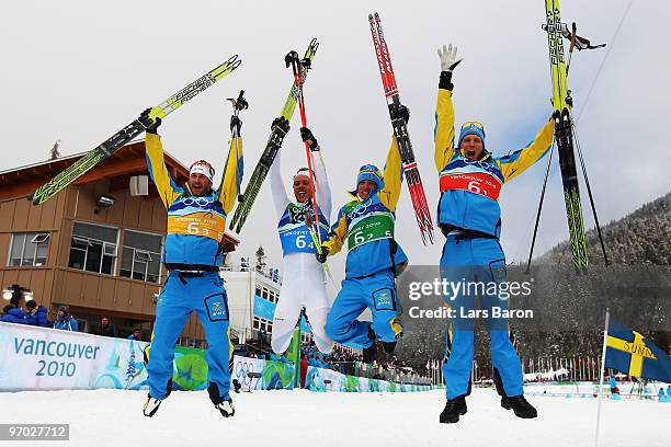 Anders Soedergren, Marcus Hellner, Johan Olsson and Daniel Richardsson of Sweden celebrate winning the gold medal during the cross country skiing...