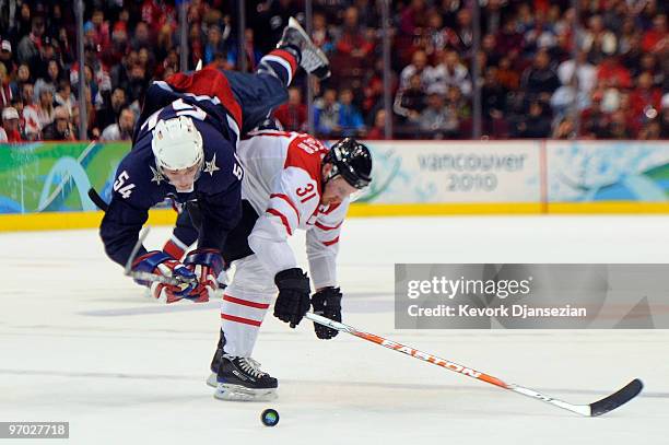 Bobby Ryan of the United States gets upended by Mathias Seger of Switzerland during the ice hockey men's quarter final game between USA and...