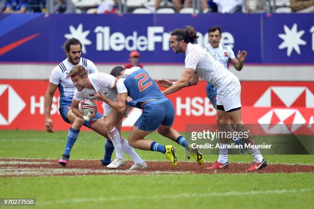 Tom Mitchell of England is tackled by Terry Bouhraoua of France during match between France and England at the HSBC Paris Sevens, stage of the Rugby...