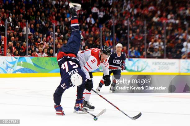 Bobby Ryan of the United States gets upended by Mathias Seger of Switzerland during the ice hockey men's quarter final game between USA and...