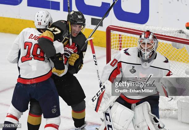 Nicklas Backstrom of the Washington Capitals and David Perron of the Vegas Golden Knights battle for position in the crease next to Braden Holtby of...