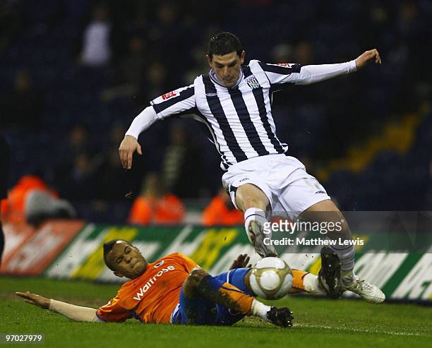 Graham Dorrans of West Bromwich is tackled by Ryan Bertrand of Reading during the FA Cup sponsored by E.on 5th Round Replay match between West...