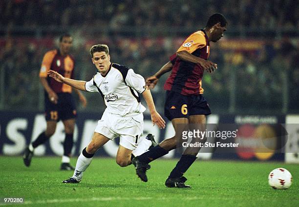 Aldair of AS Roma reaches the ball first ahead of Michael Owen of Liverpool during the UEFA Champions League Group B match played at the Stadio...