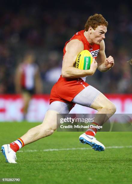 Gary Rohan of the Swans runs with the ball before he kicks a goal during the round 12 AFL match between the St Kilda Saints and the Sydney Swans at...
