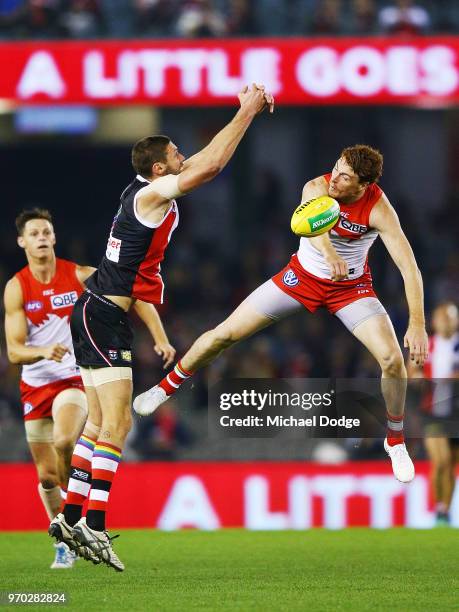 Gary Rohan of the Swans competes for the ball against Tom Hickey of the Saints during the round 12 AFL match between the St Kilda Saints and the...