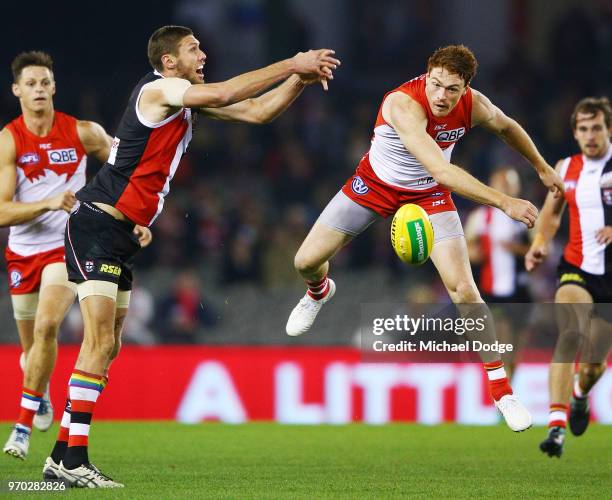 Gary Rohan of the Swans competes for the ball against Tom Hickey of the Saints during the round 12 AFL match between the St Kilda Saints and the...