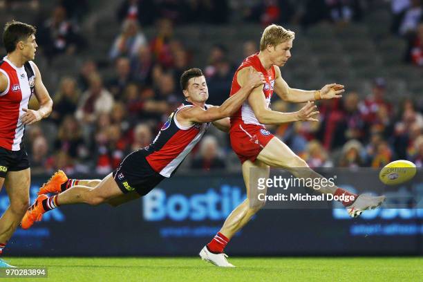 Jack Sinclair of the Saints tackles Isacc Heeney of the Swans during the round 12 AFL match between the St Kilda Saints and the Sydney Swans at...