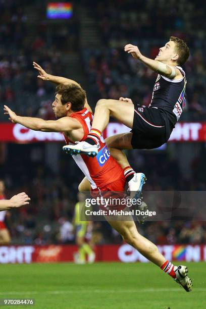 Jack Lonie of the Saints attempts a high mark over Nick Smith of the Swans during the round 12 AFL match between the St Kilda Saints and the Sydney...