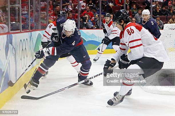 Tim Gleason of the United States handles the puck against Julien Sprunger of Switzerland during the ice hockey men's quarter final game between USA...