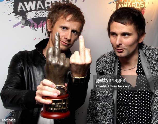 Muse, Dominic Howard and Matt Bellamy pose with their award for Best British Bandl at the Shockwaves NME Awards 2010 at Brixton Academy on February...