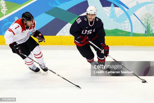 Patrick Kane of the United States battles for the puck with Mark Streit of Switzerland during the ice hockey men's quarter final game between USA and...