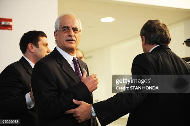 Aides escort Argentine Foreign Minister Jorge E. Taiana from a press conference on February 24, 2010 just after Taiana met with United Nations...