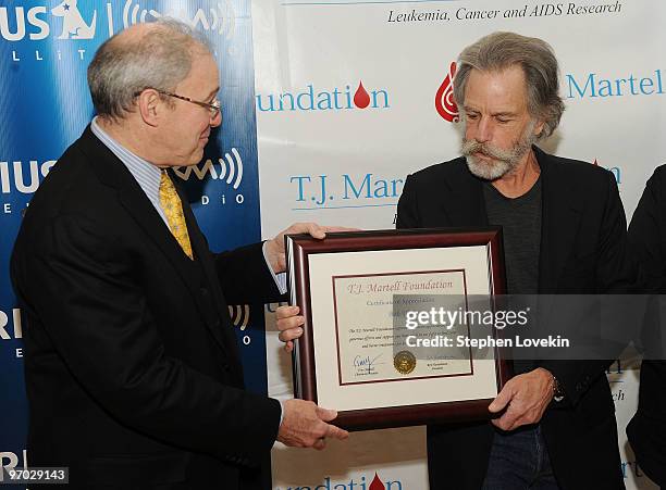 President of the Board of The T.J. Martell Foundation Ron Hartenbaum honors singer/musician Bob Weir with a plaque for his support at SIRIUS XM...