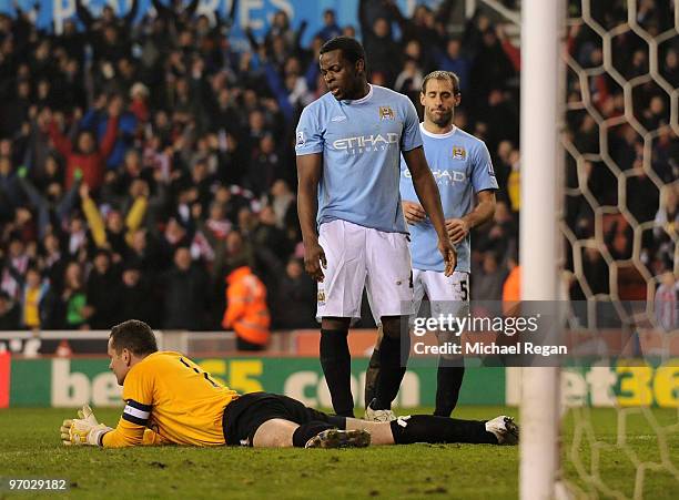 Goalkeeper Shay Given of Manchester City lies dejected after conceding the Stoke's second goal as team mates Nedum Onuoha and Pablo Zabaleta look on...