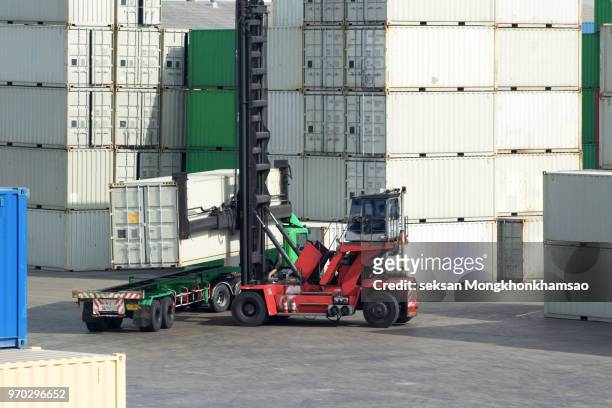 crane lifter handling container box loading to truck in import export logistic zone - material handling stock pictures, royalty-free photos & images