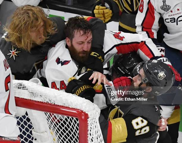 William Karlsson of the Vegas Golden Knights grabs Brooks Orpik of the Washington Capitals as he hits Alex Tuch of the Golden Knights after a...