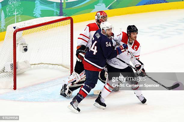 Bobby Ryan of the United States checks Mark Streit of Switzerland in front of the net in the third period during the ice hockey men's quarter final...