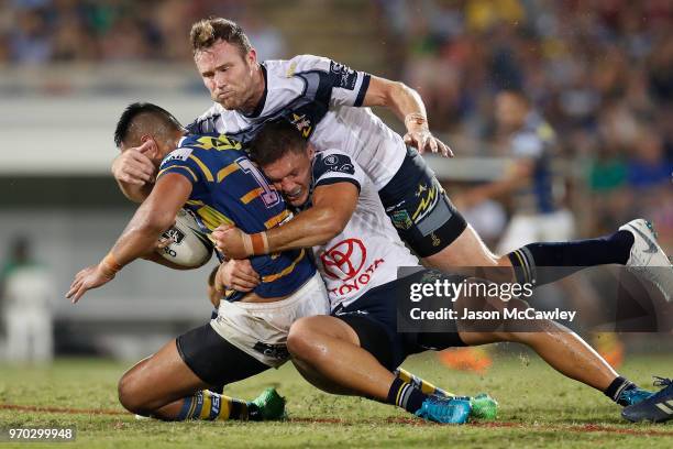 Marata Niukore of the Eels is tackled during the round 14 NRL match between the Parramatta Eels and the North Queensland Cowboys at TIO Stadium on...