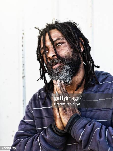 homeless man prays for a better future - rastafari hair stock pictures, royalty-free photos & images