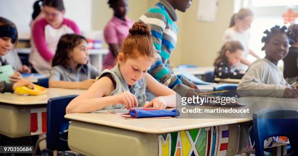 elementary school children taking their places in classroom. - "martine doucet" or martinedoucet stock pictures, royalty-free photos & images