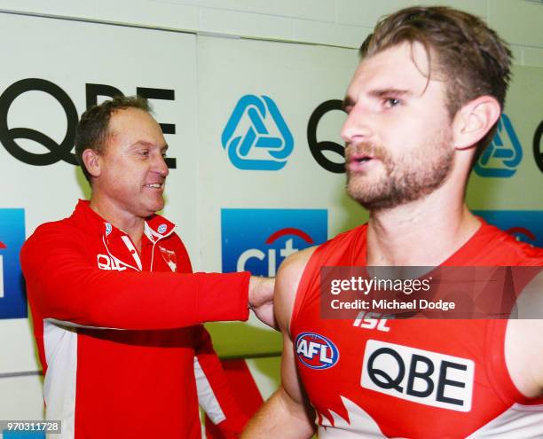 Swans head coach John Longmire with Daniel Robinson of the Swans during the round 12 AFL match between the St Kilda Saints and the Sydney Swans at...