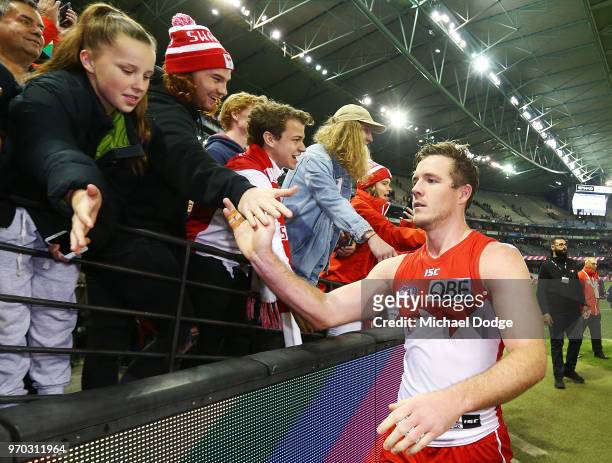 Luke Parker of the Swans celebrates the win with fans during the round 12 AFL match between the St Kilda Saints and the Sydney Swans at Etihad...