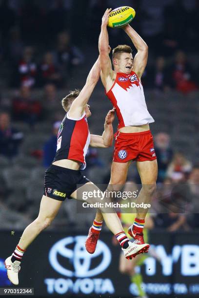 Ben Ronke of the Swans marks the ball aaginst Ed Phillips of the Saints during the round 12 AFL match between the St Kilda Saints and the Sydney...