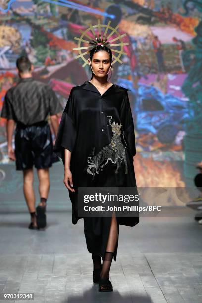 Model walks the runway at the Edward Crutchley show during London Fashion Week Men's June 2018 at BFC Show Space on June 9, 2018 in London, England.