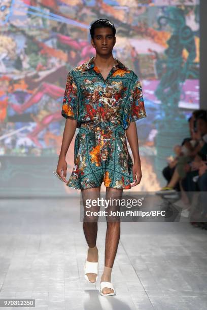 Model walks the runway at the Edward Crutchley show during London Fashion Week Men's June 2018 at BFC Show Space on June 9, 2018 in London, England.