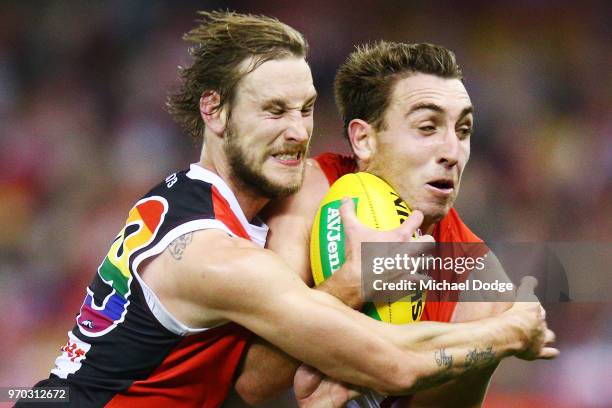 Jimmy Webster of the Saints tackles Daniel Robinson of the Swans during the round 12 AFL match between the St Kilda Saints and the Sydney Swans at...