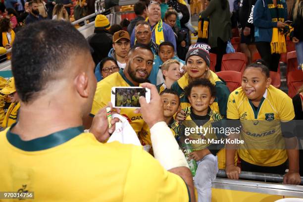 Tolu Latu of the Wallabies takes a picture of Sekope Kepu of the Wallabies and his family after the International Test match between the Australian...