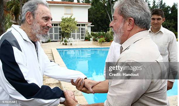 In this handout image provided by the Brazlian Presidency, First Secretary of the Communist Party of Cuba Fidel Castro greets Brazil�s President Luiz...