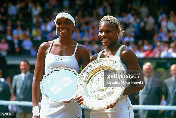 Wimbledon Ladies champion Serena Williams of the USA poses with the winning trophy with runner-up and sister Venus Williams of the USA at the...