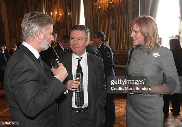 Prince Philippe of Belgium and Member of the European Commission Karel De Gucht and his wife Mireille Schreurs talk during a reception for the...