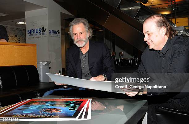 Musician Bob Weir autographs a poster by artist Ioannis at the T.J. Martell Foundation's special commemorative plaque presentation at SIRIUS XM...
