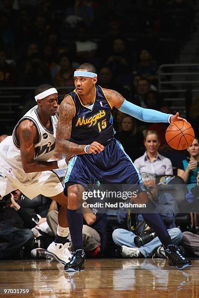 Carmelo Anthony of the Denver Nuggets posts up against Josh Howard of the Washington Wizards during the game on February 19, 2010 at the Verizon...