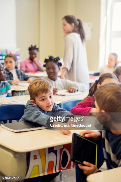 elementary school children misbehaving in classroom. - "martine doucet" or martinedoucet stock pictures, royalty-free photos & images