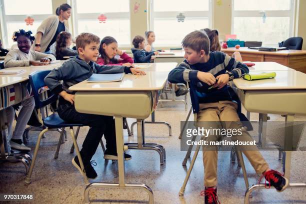 elementary school children misbehaving in classroom. - "martine doucet" or martinedoucet stock pictures, royalty-free photos & images