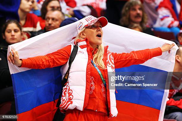 Fan of Russia holds a flag in the stands during the ice hockey men's quarter final game between Russia and Canada on day 13 of the Vancouver 2010...