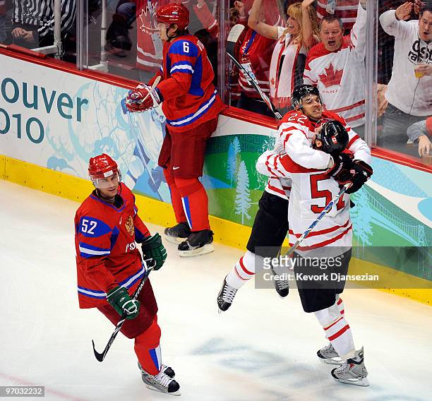 Ryan Getzlaf of Canada celebrates with Dan Boyle of Canada after scoring a goal against Evgeny Nabokov of Russia as Victor Kozlov skate by during the...