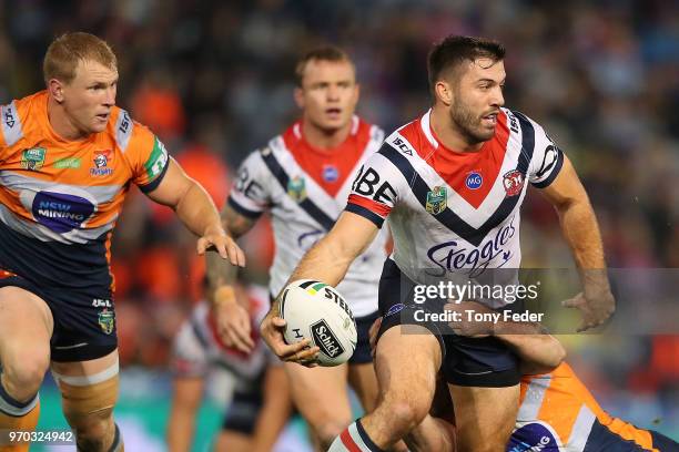 James Tedesco of the Roosters is tackled during the round 14 NRL match between the Newcastle Knights and the Sydney Roosters at McDonald Jones...