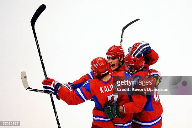 Dmitri Kalinin of Russia celebrates with his team after scoring against Canada during the ice hockey men's quarter final game between Russia and...