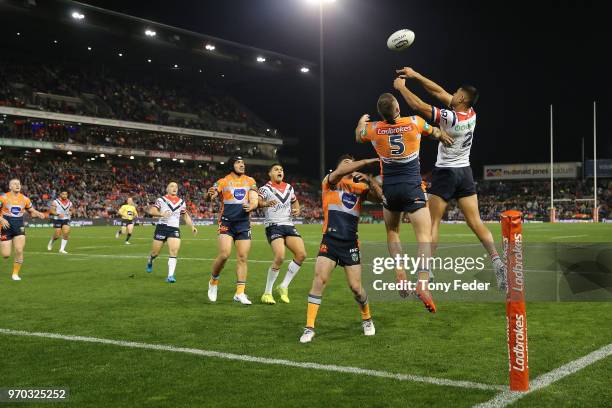 Daniel Tupou of the Roosters and Shaun Kenny-Dowall of the Knights contest the ball during the round 14 NRL match between the Newcastle Knights and...