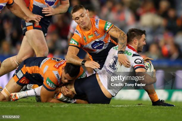 James Tedesco of the Roosters is tackled during the round 14 NRL match between the Newcastle Knights and the Sydney Roosters at McDonald Jones...