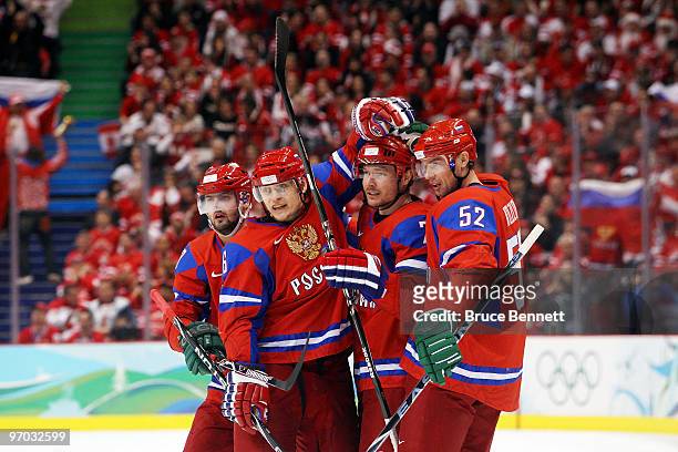 Dmitri Kalinin of Russia celebrates with his team after scoring against Canada during the ice hockey men's quarter final game between Russia and...