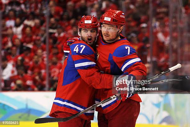 Dmitri Kalinin of Russia celebrates with Alexander Radulov after scoring against Canada during the ice hockey men's quarter final game between Russia...