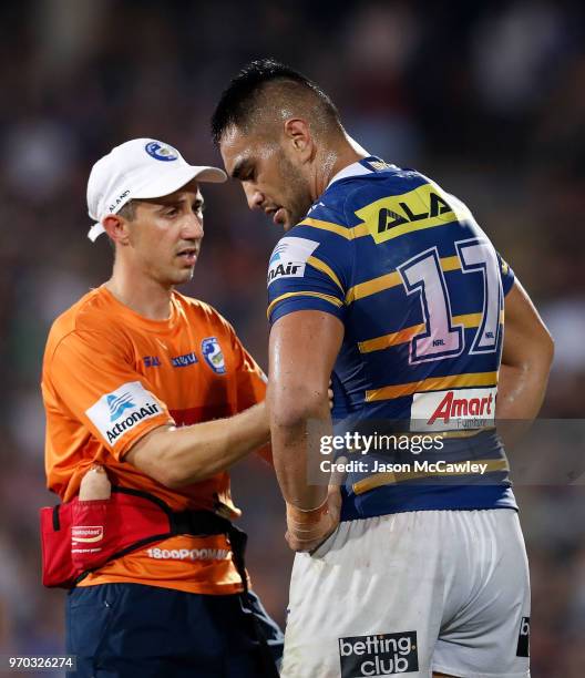 Marata Niukore of the Eels is assisted from the field during the round 14 NRL match between the Parramatta Eels and the North Queensland Cowboys at...